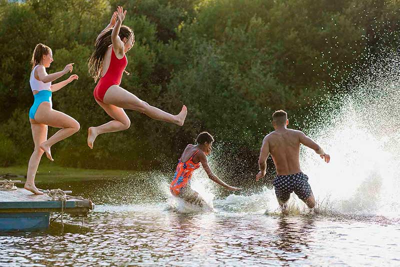 teens jumping into the lake